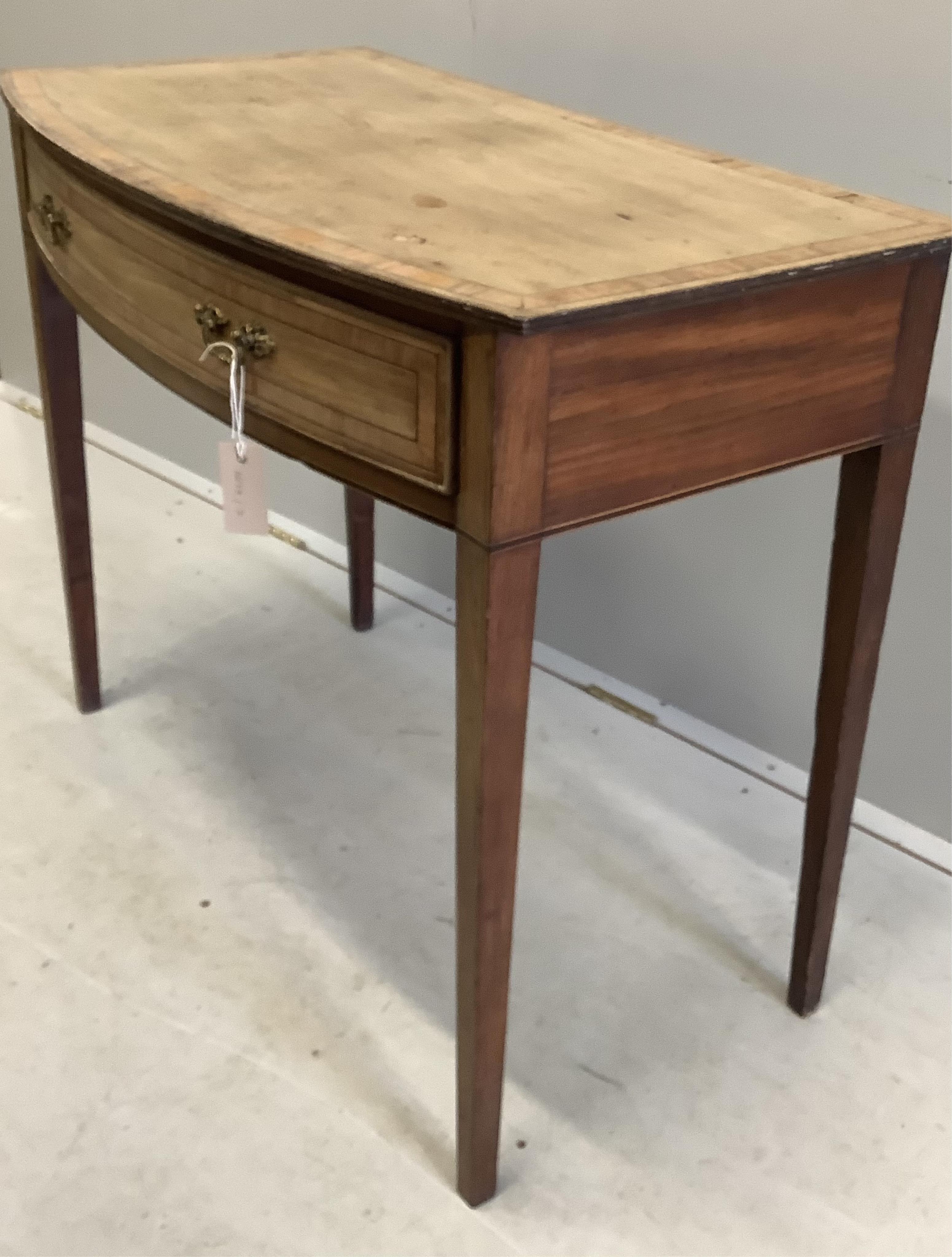 A George III faded banded mahogany bowfront side table, width 91cm, depth 49cm, height 76cm. Condition - poor to fair